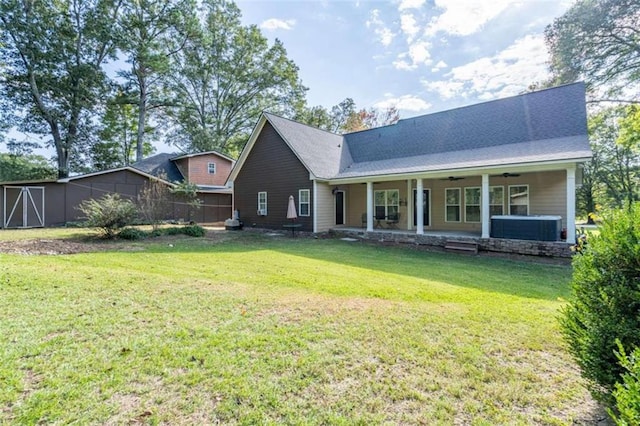 back of house featuring covered porch, a lawn, and ceiling fan