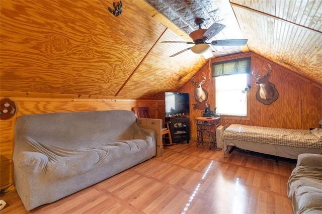 living room featuring wood ceiling, ceiling fan, lofted ceiling, wooden walls, and hardwood / wood-style flooring