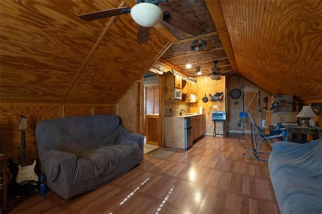 living room with sink, ceiling fan, wooden ceiling, vaulted ceiling, and wooden walls