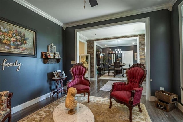 living area featuring ceiling fan with notable chandelier, ornamental molding, and dark hardwood / wood-style floors