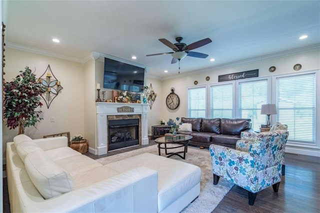 living room featuring crown molding, wood-type flooring, and ceiling fan