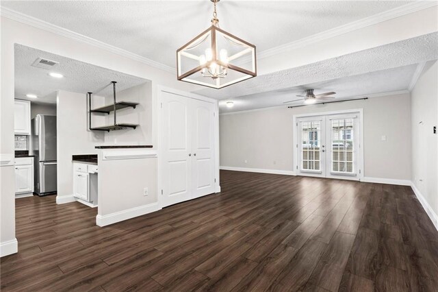 living room with dark hardwood / wood-style floors, ceiling fan, crown molding, and a textured ceiling