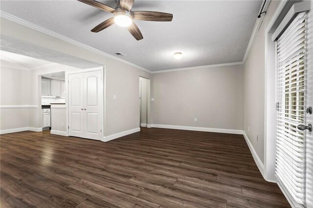 living room featuring ceiling fan with notable chandelier, a textured ceiling, dark hardwood / wood-style floors, and crown molding