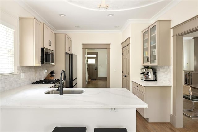 2876 White Oak Dr, Decatur, GA 30032 - kitchen with appliances with stainless steel finishes, a sink, a peninsula, glass insert cabinets, and tasteful backsplash