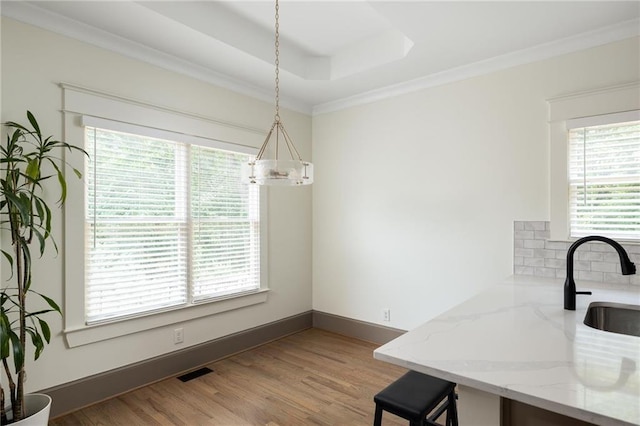 2876 White Oak Dr, Decatur, GA 30032 - dining area featuring wood finished floors, crown molding, a chandelier, baseboards, and a raised ceiling