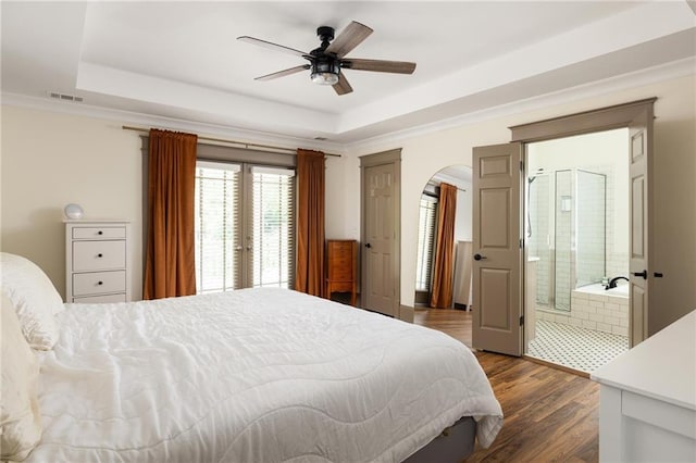 2876 White Oak Dr, Decatur, GA 30032 - bedroom featuring a tray ceiling, arched walkways, dark wood-style floors, a ceiling fan, and ornamental molding
