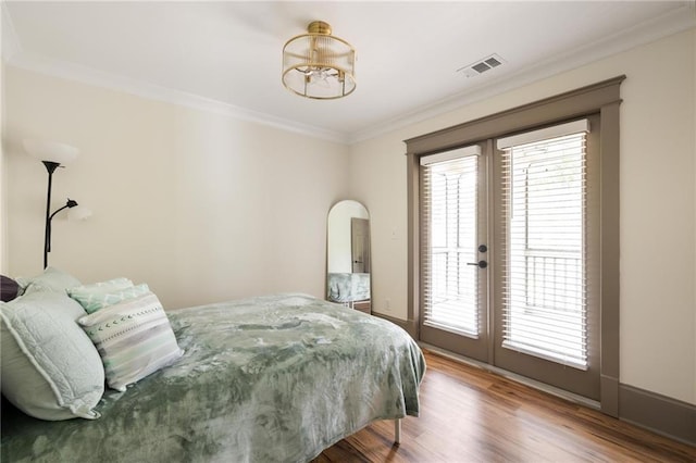2876 White Oak Dr, Decatur, GA 30032 - bedroom featuring crown molding, access to outside, wood finished floors, french doors, and a chandelier