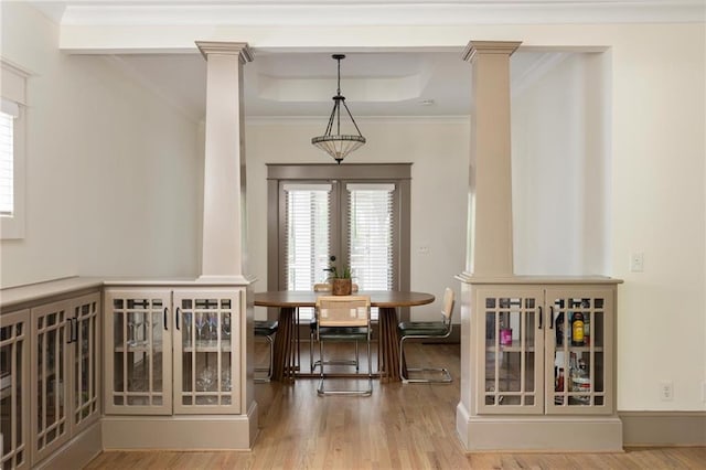 2876 White Oak Dr, Decatur, GA 30032 - dining room featuring ornate columns, french doors, wood finished floors, a tray ceiling, and crown molding