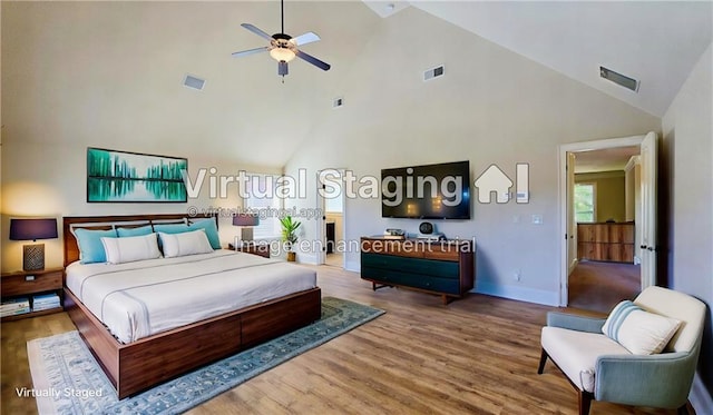 bedroom featuring wood-type flooring and high vaulted ceiling