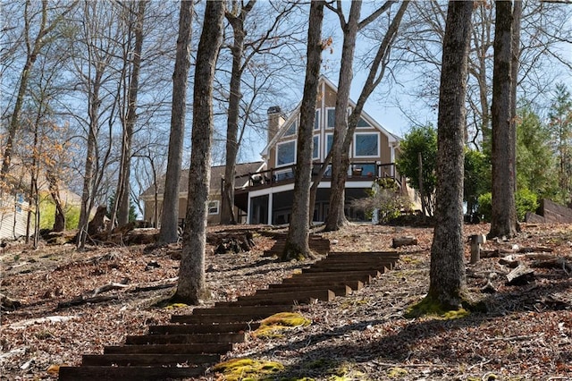 exterior space with stairway and a chimney