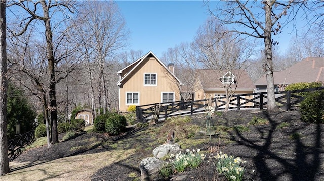 exterior space with fence and a chimney