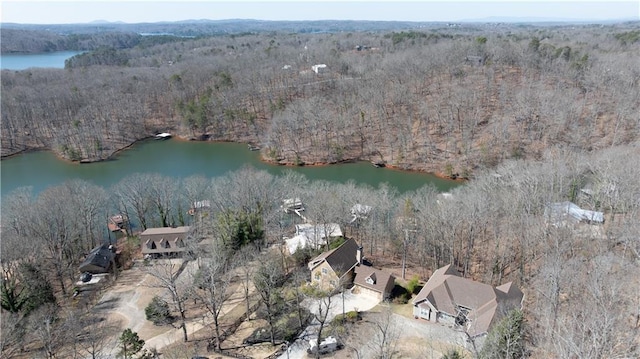 aerial view featuring a forest view and a water view