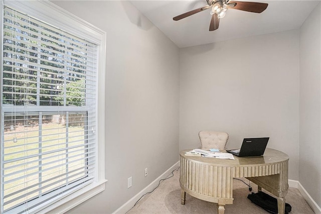 carpeted office featuring baseboards and ceiling fan