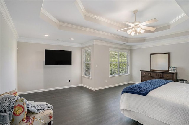 bedroom featuring a raised ceiling, dark wood finished floors, crown molding, baseboards, and ceiling fan