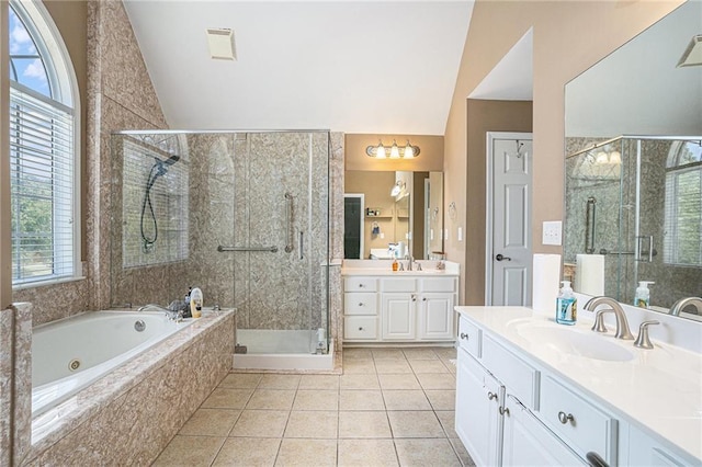 bathroom featuring healthy amount of natural light, lofted ceiling, a stall shower, and tile patterned floors