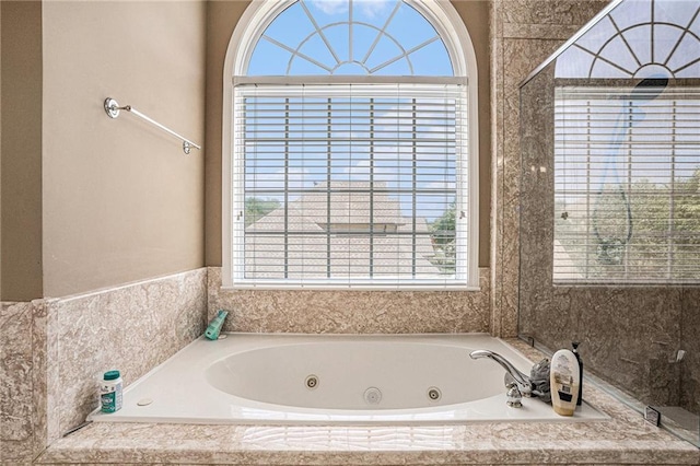bathroom featuring a tub with jets