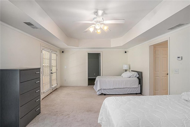 bedroom with light carpet, a tray ceiling, access to outside, french doors, and ceiling fan