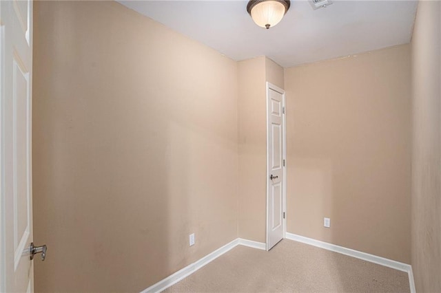 empty room with baseboards and light carpet