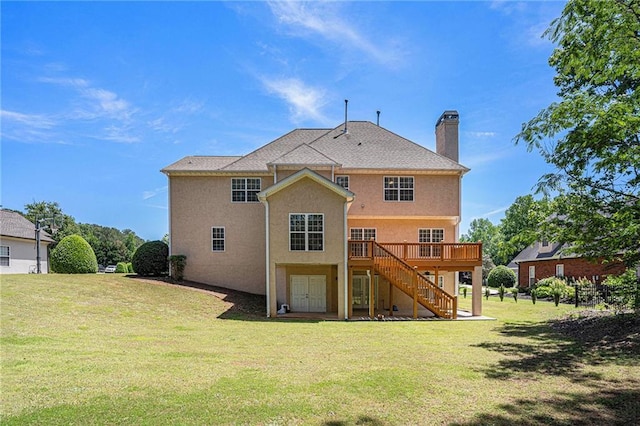 rear view of property featuring stairs, a chimney, a deck, a yard, and stucco siding