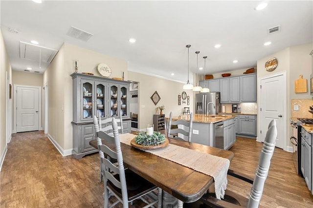 3735 Westhaven Dr, Cumming, GA 30040 - dining space featuring attic access, wood finished floors, and recessed lighting