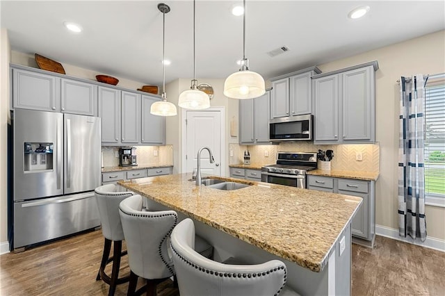 3735 Westhaven Dr, Cumming, GA 30040 - kitchen with appliances with stainless steel finishes, gray cabinetry, dark wood-type flooring, an island with sink, and recessed lighting