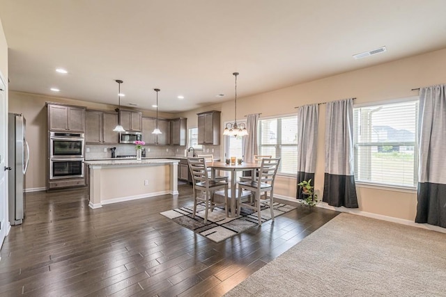 171 Osier Dr, Mcdonough, GA 30252 - dining space with baseboards, dark wood-style floors, recessed lighting, and a chandelier