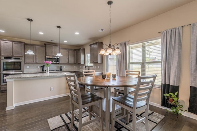 171 Osier Dr, Mcdonough, GA 30252 - dining room featuring dark wood-style floors, recessed lighting, baseboards, and a chandelier