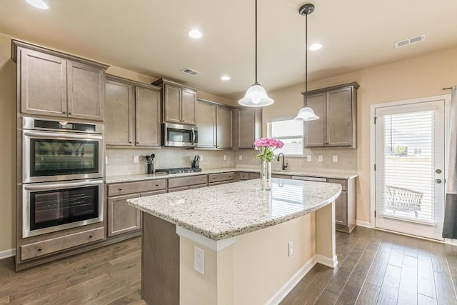 171 Osier Dr, Mcdonough, GA 30252 - kitchen featuring appliances with stainless steel finishes, dark wood-style floors, baseboards, decorative backsplash, and recessed lighting