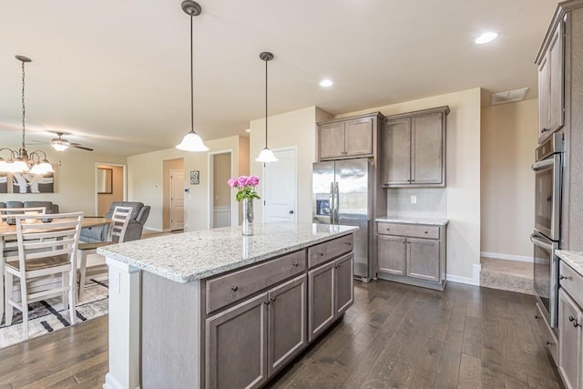 171 Osier Dr, Mcdonough, GA 30252 - kitchen featuring appliances with stainless steel finishes, dark wood finished floors, pendant lighting, and recessed lighting
