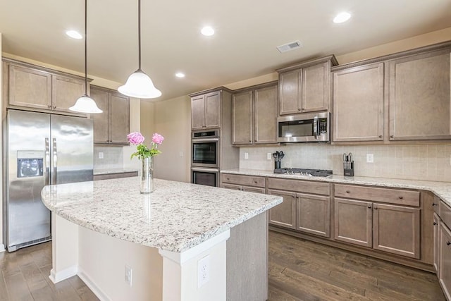 171 Osier Dr, Mcdonough, GA 30252 - kitchen with stainless steel appliances, dark wood-style floors, a kitchen island, backsplash, and recessed lighting