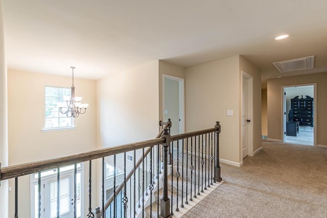 171 Osier Dr, Mcdonough, GA 30252 - hall with an upstairs landing, attic access, light colored carpet, baseboards, and a chandelier