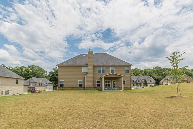 171 Osier Dr, Mcdonough, GA 30252 - back of property featuring a lawn, a chimney, and roof with shingles