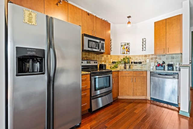 kitchen with light stone counters, appliances with stainless steel finishes, tasteful backsplash, and dark hardwood / wood-style floors