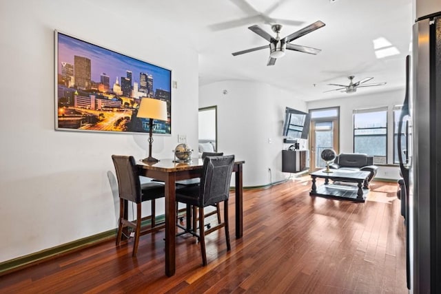 dining space featuring ceiling fan and dark wood-type flooring