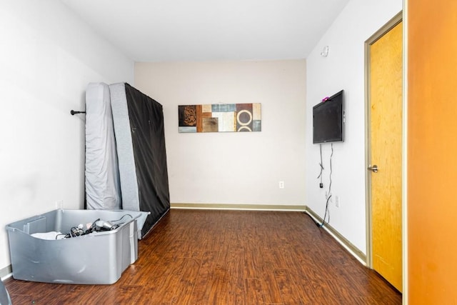 hallway with dark hardwood / wood-style floors