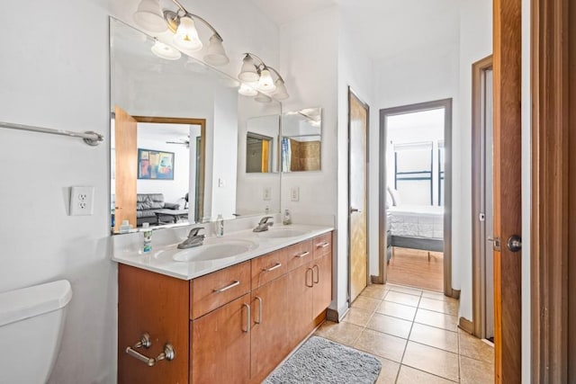 bathroom with vanity, tile patterned flooring, toilet, and ceiling fan