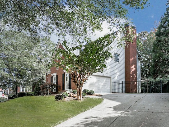 view of front of home featuring a garage and a front lawn