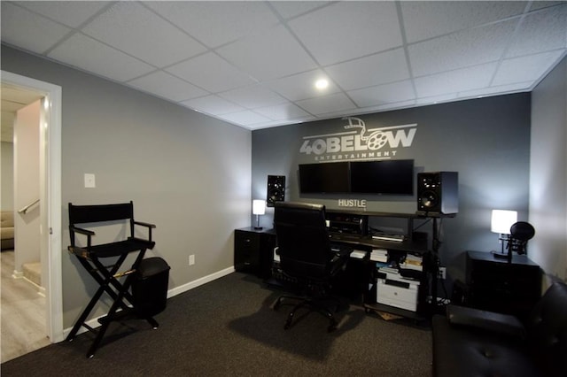 office featuring a paneled ceiling and baseboards