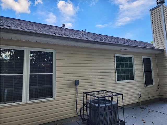 835 Amelia Grove Ln, Lawrenceville, GA 30045 - back of house featuring a chimney, roof with shingles, a patio area, and cooling unit