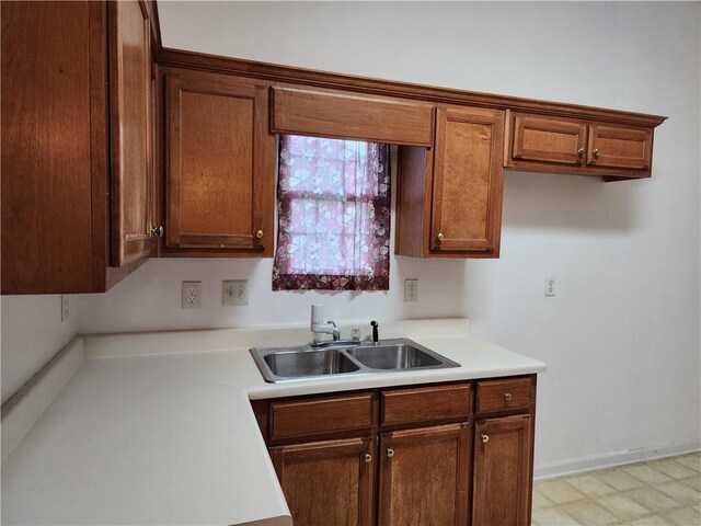 835 Amelia Grove Ln, Lawrenceville, GA 30045 - kitchen with light countertops, brown cabinetry, light floors, and a sink