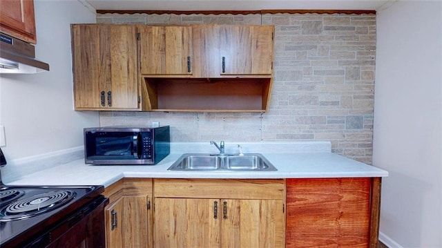 kitchen with black range with electric stovetop, sink, and decorative backsplash