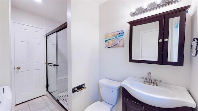 bathroom with an enclosed shower, vanity, tile patterned flooring, and toilet