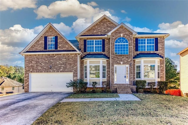 view of front of home featuring a garage and a front lawn