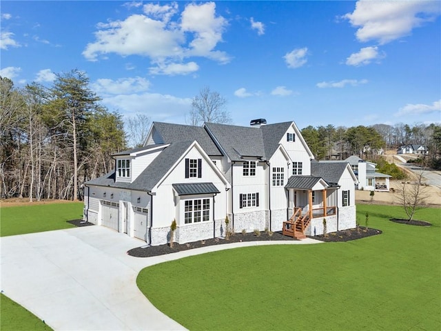 modern farmhouse with roof with shingles, a standing seam roof, metal roof, driveway, and a front lawn