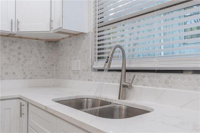 4922 Glenside Ct, Stone Mountain, GA 30088 - kitchen with a sink, white cabinets, and light stone countertops