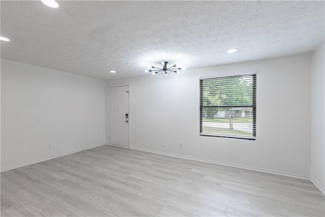 4922 Glenside Ct, Stone Mountain, GA 30088 - empty room featuring a textured ceiling, light wood-style flooring, recessed lighting, a chandelier, and baseboards