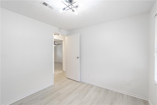 4922 Glenside Ct, Stone Mountain, GA 30088 - empty room featuring light wood-style flooring, a chandelier, and baseboards