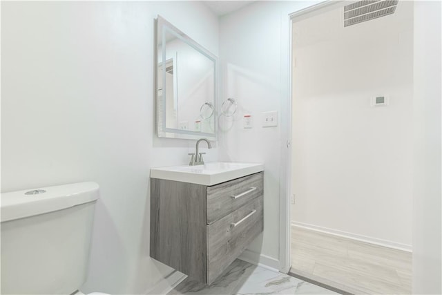 4922 Glenside Ct, Stone Mountain, GA 30088 - half bathroom with vanity, toilet, baseboards, and marble finish flooring