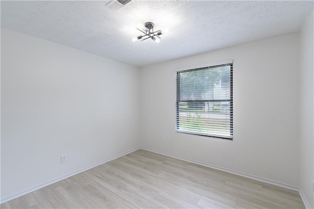 4922 Glenside Ct, Stone Mountain, GA 30088 - empty room featuring light wood-type flooring, a textured ceiling, and baseboards