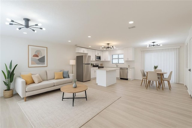 4922 Glenside Ct, Stone Mountain, GA 30088 - living room with a chandelier, recessed lighting, light wood-type flooring, and baseboards
